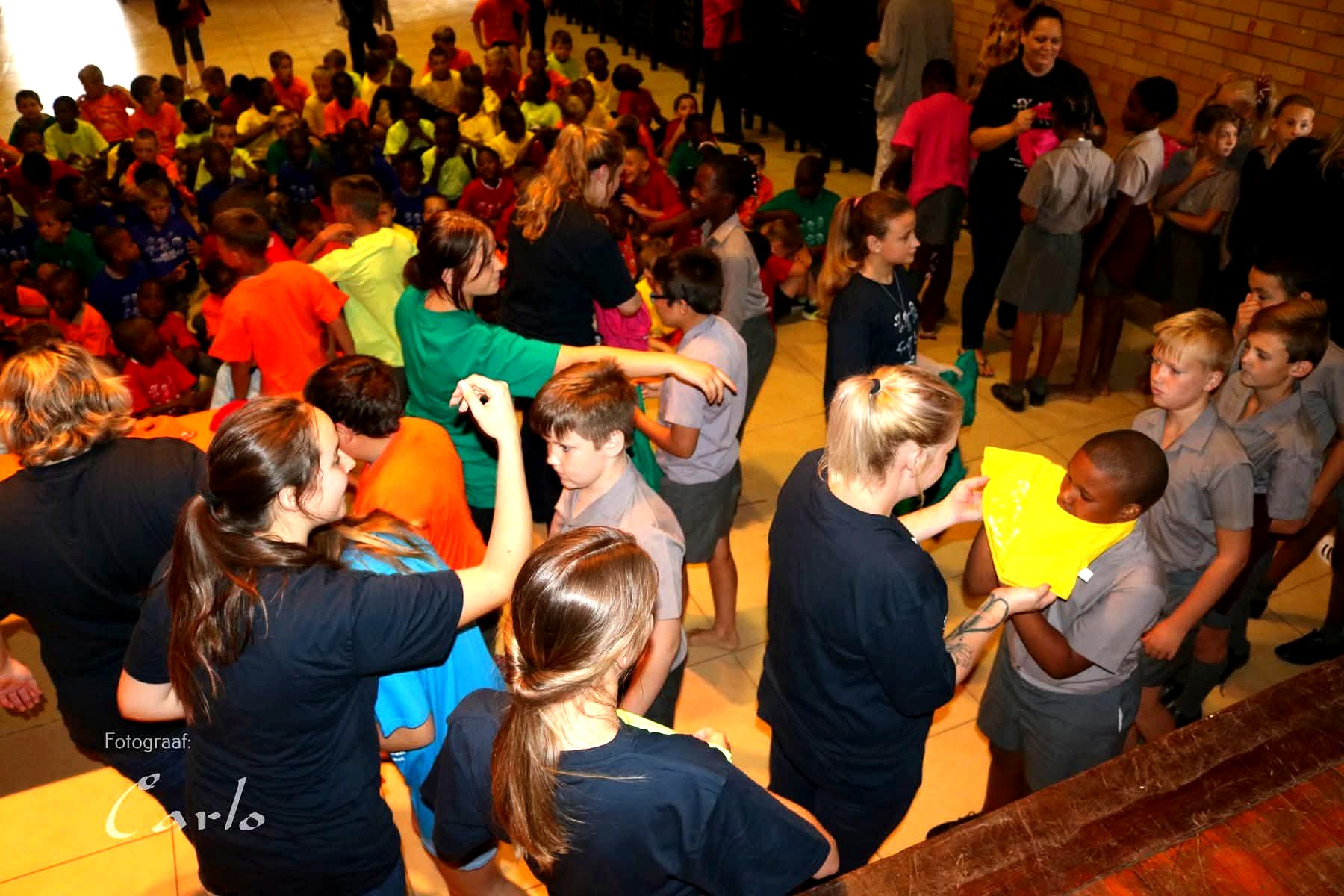 Volunteers handing out t-shirts to children at the event