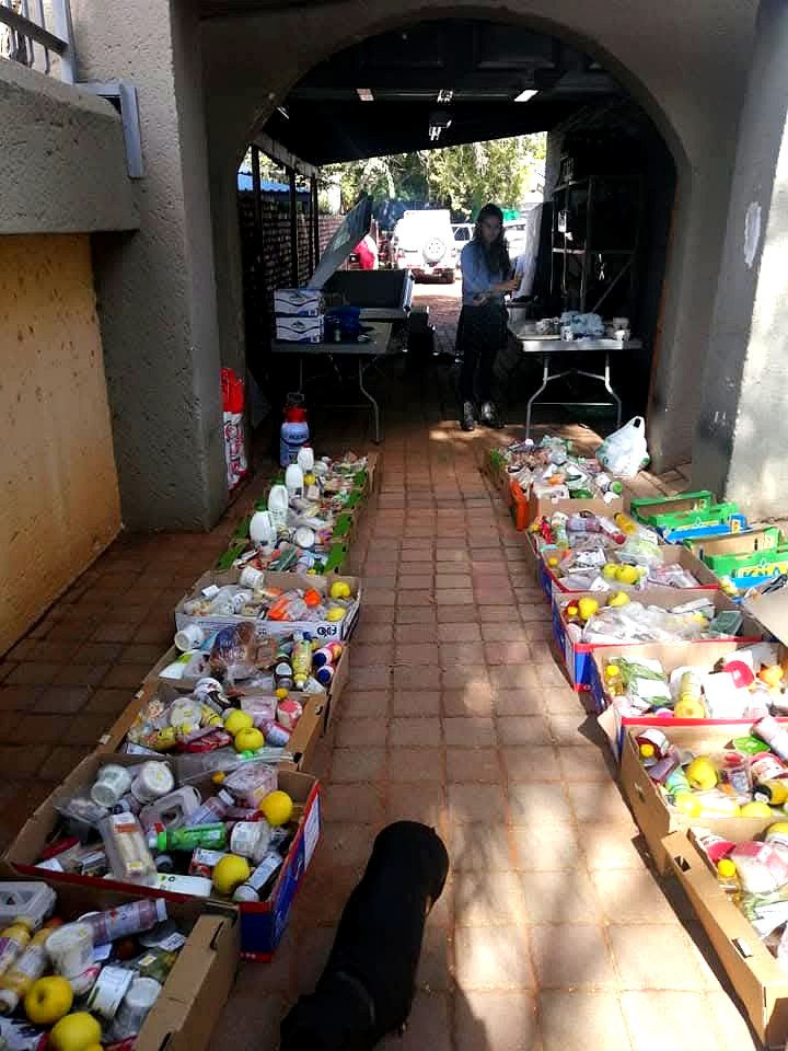 Long corridor lined with boxes of food and supplies ready for collection