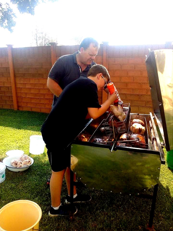 Volunteers grilling chicken for a community food drive