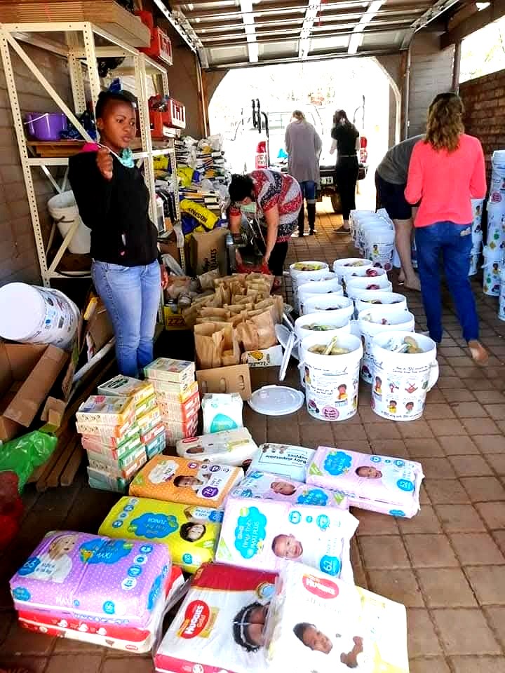 Volunteers packing food parcels and diapers in the garage